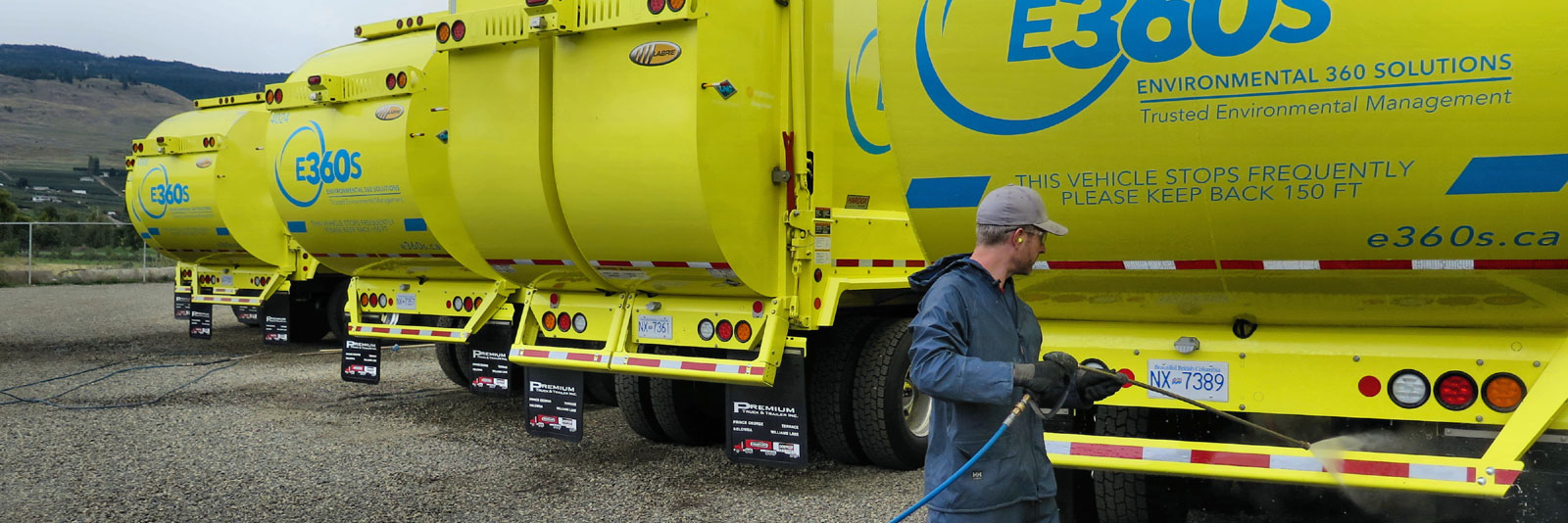 fleet of sparkling clean dump trucks after power washing